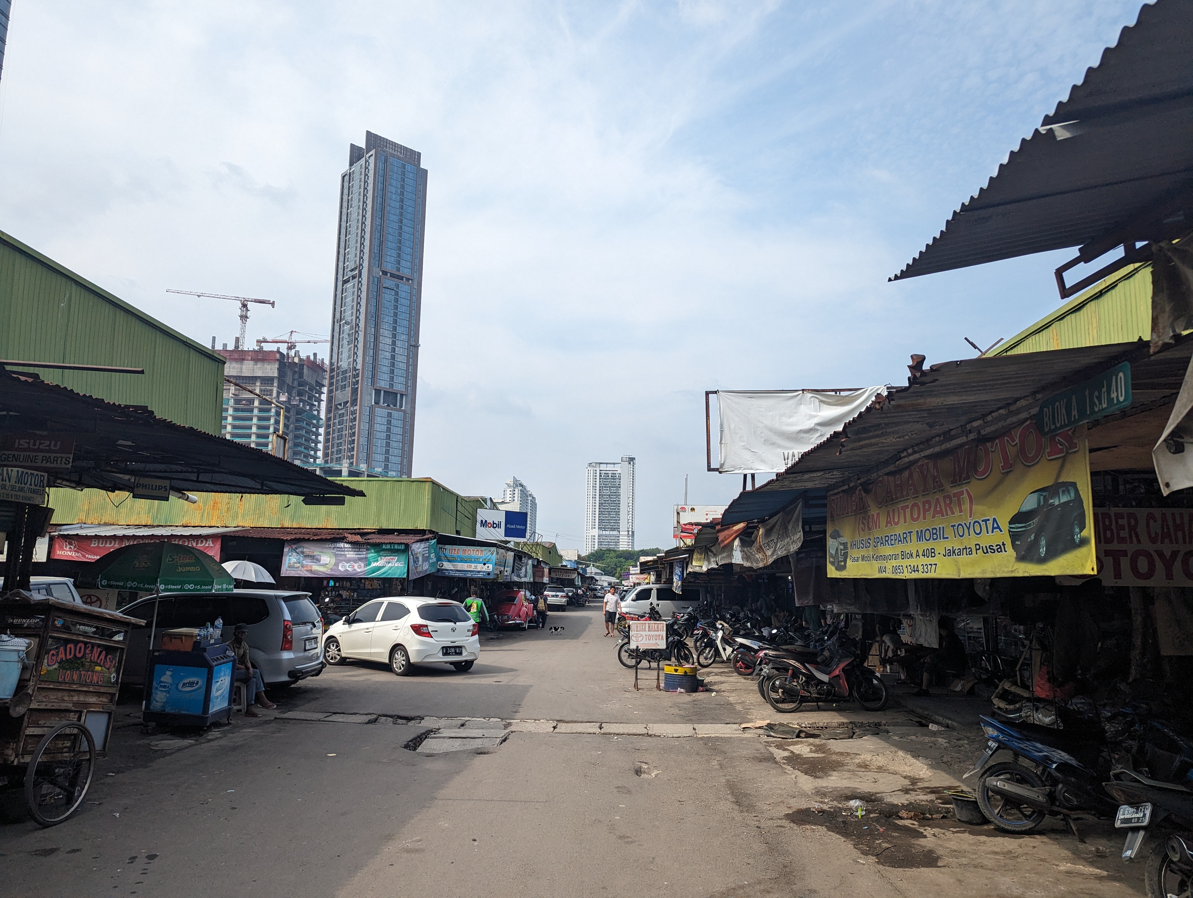 Car repair districts like this one in Jakarta can stretch kilometers on end. Air conditioning repair shops can dominate entire blocks. Photo: Tilden Chao, 2023.